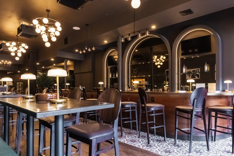 High-top tables beneath the chandeliers
